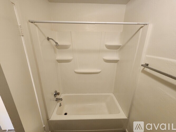 A white bathroom with a tub and a shower.