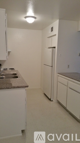 A bathroom with a sink, toilet and mirror.