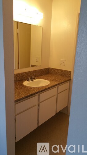 A bathroom with a sink and mirror.