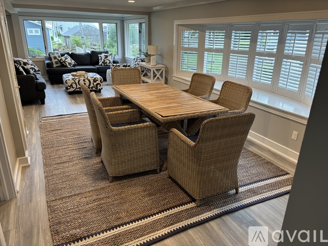 A dining room with a wooden table and chairs.