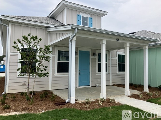 A house with a blue door and a porch.