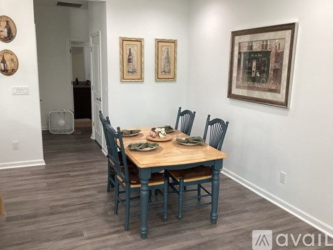 A dining room with a wooden table and chairs.