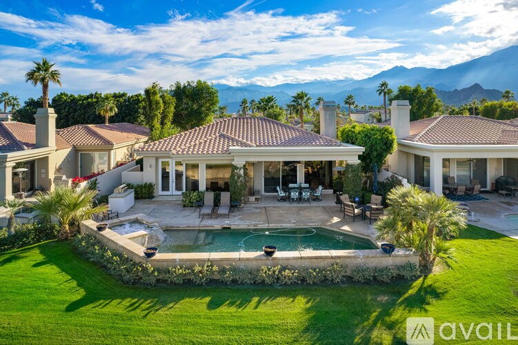 A large house with a pool in the backyard.