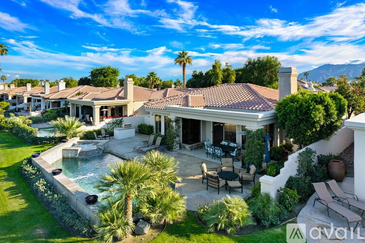 A large house with a pool in the backyard.