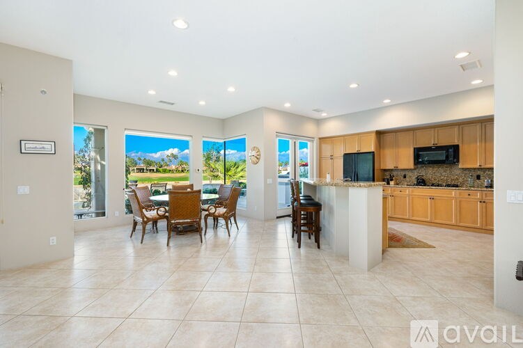 A spacious kitchen and dining area with a view of the outdoors.