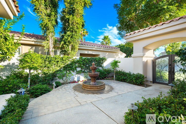 A beautiful outdoor patio area with a fountain in the center.