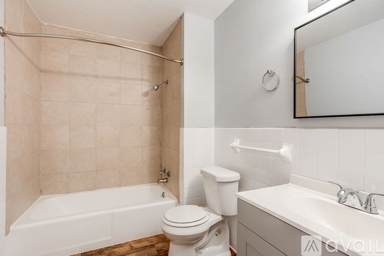 A bathroom with a toilet, sink, and bathtub.