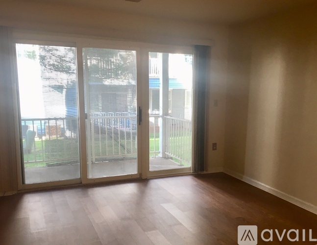 A room with a sliding door leading to a balcony.