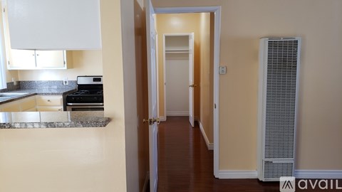 A kitchen with a stove top oven and a white cabinet.
