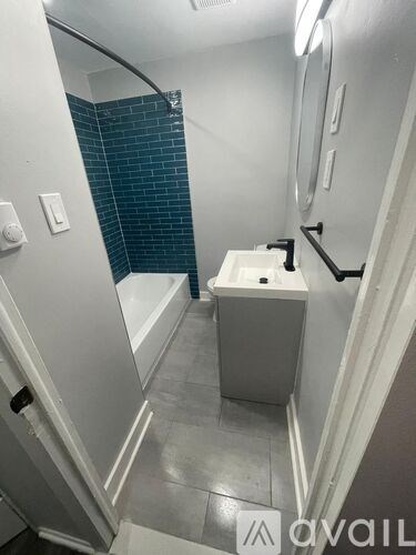 A small white bathroom with a toilet and a shower.
