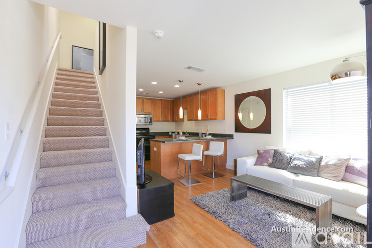 A living room with a staircase leading to the upper floor.