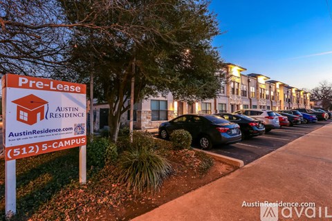 A sign for a pre-lease Austin residence is displayed in front of a building.