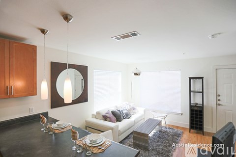 A modern dining room with a black table and a white couch.