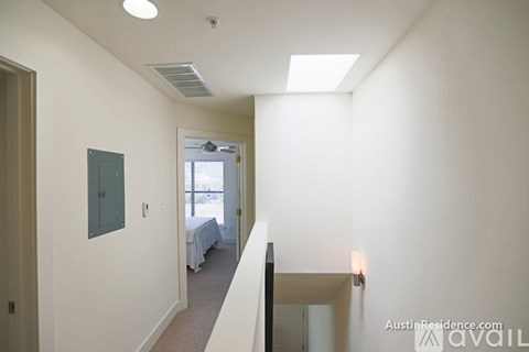 A bedroom with a bed and a window.