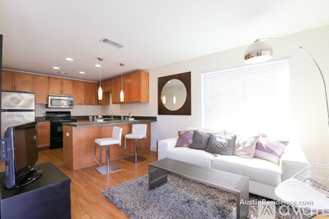 A modern living room with a white couch and a television.