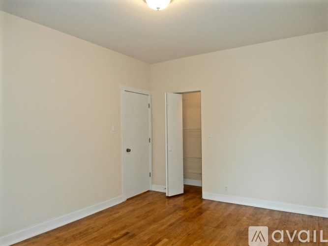 A room with two doors and wooden floors.