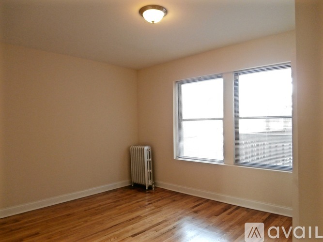 A room with a radiator and a window.