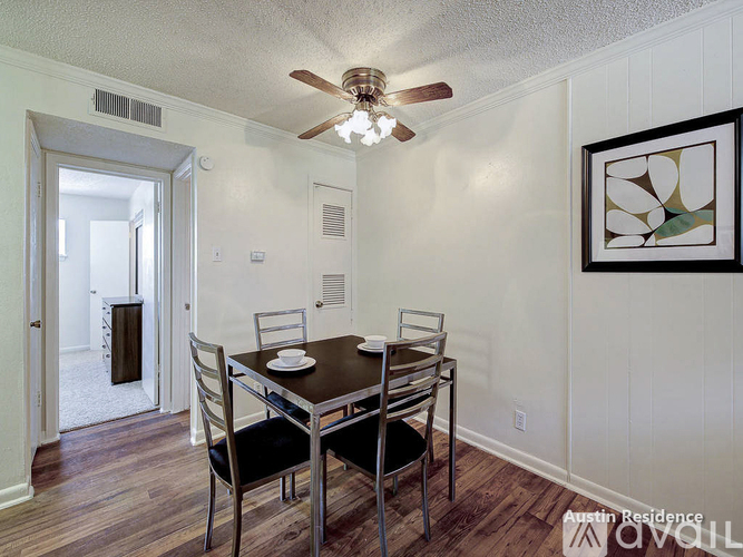 A dining room with a table and chairs.