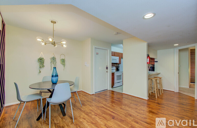 A dining room with a table and chairs.