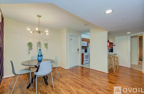 A dining room with a table and chairs.