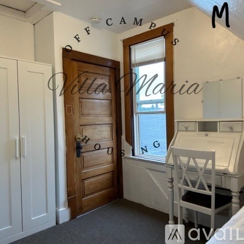 A room with a wooden door and a window with blinds.