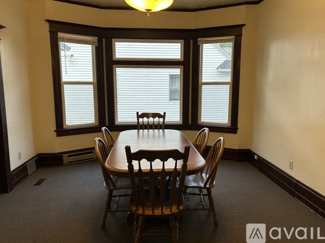 A dining room with a table and chairs.
