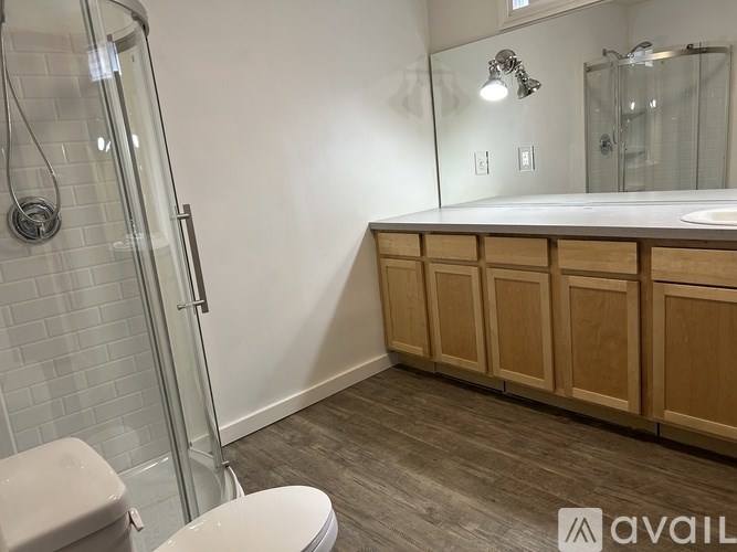 A bathroom with a toilet, sink, and shower.