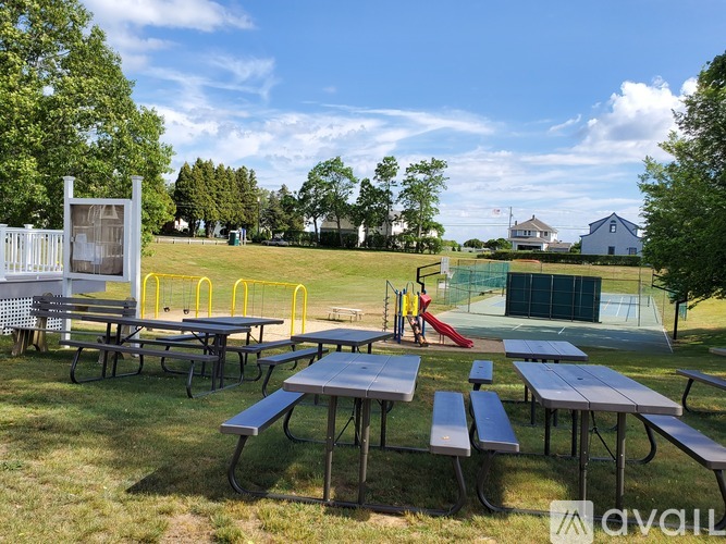 A park with picnic tables and a playground.
