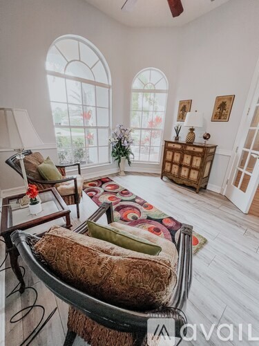 A living room with a chaise lounge chair and a rug.