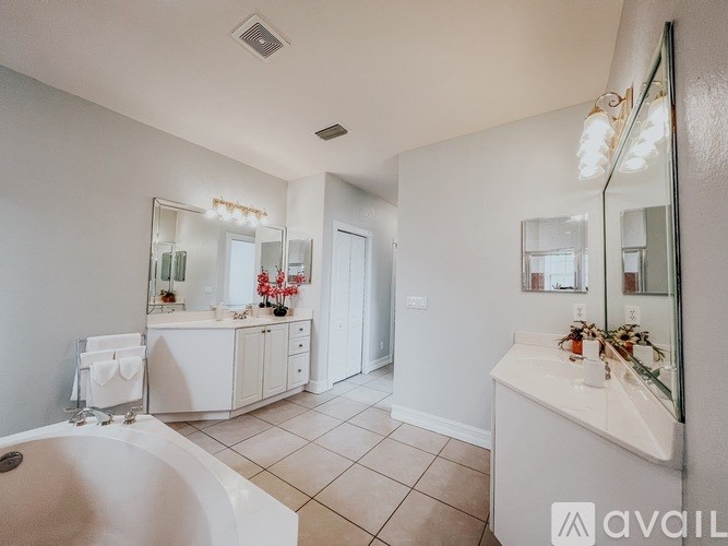 A bathroom with a white tub and sink.