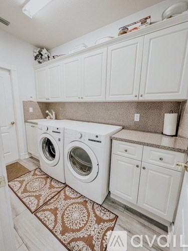 A small laundry room with a washer and dryer.