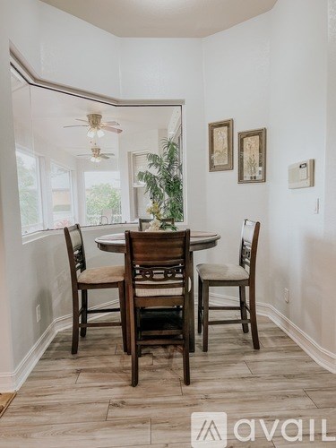 A dining room with a table and chairs.