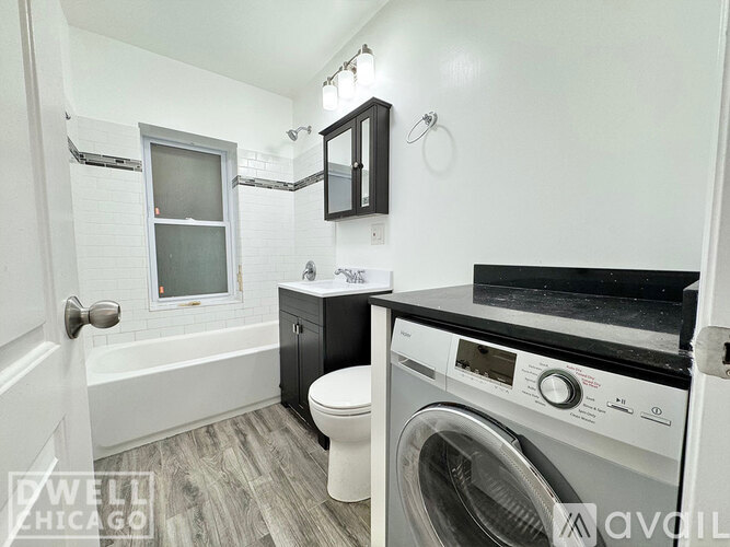 A kitchen with white appliances and cabinets.