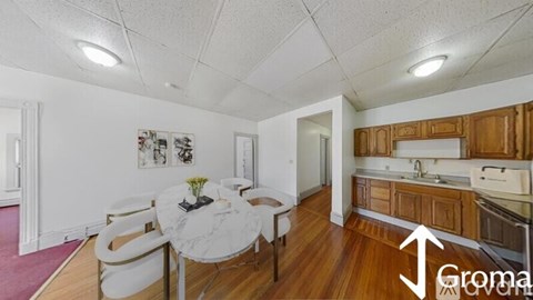 A dining area with a white table and chairs is shown in the image.