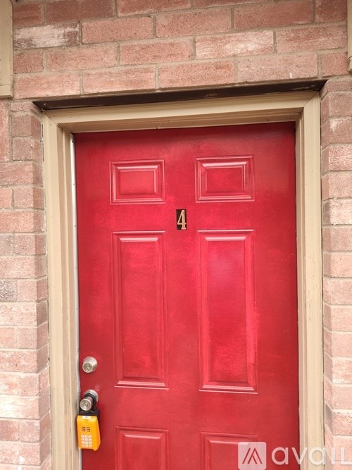 A red door with a lock and a number 4 on it.