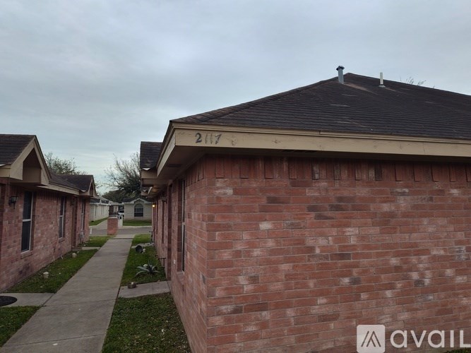 A brick house with the number 2117 on the top of it.