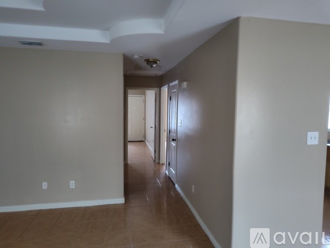 A room with a wooden floor and white walls.