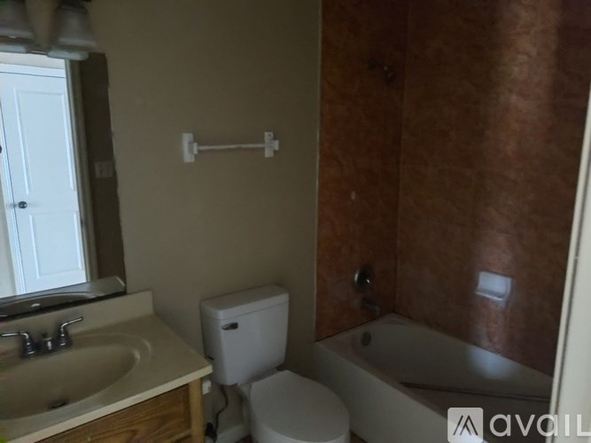 A bathroom with a toilet, sink, and bathtub.