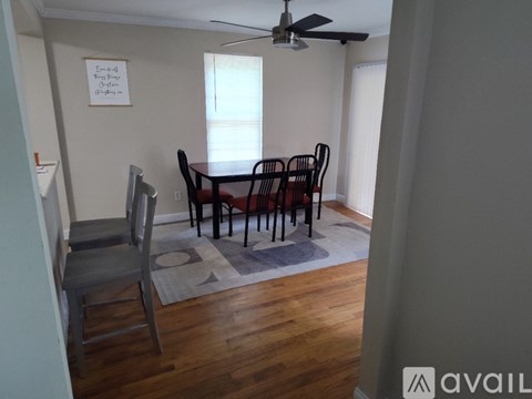 A dining room with a table and chairs.