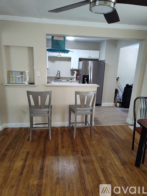 A kitchen with a wooden floor and a white countertop.
