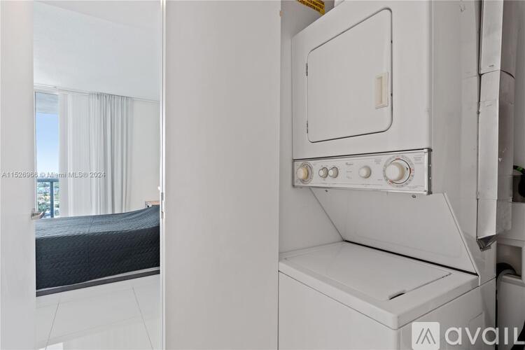 A white oven with a control panel on top is in a kitchen.