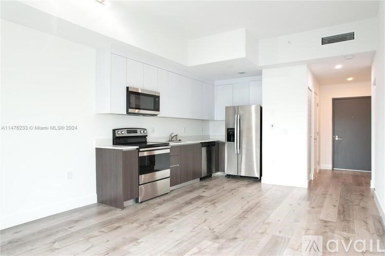 A kitchen with white cabinets and stainless steel appliances.