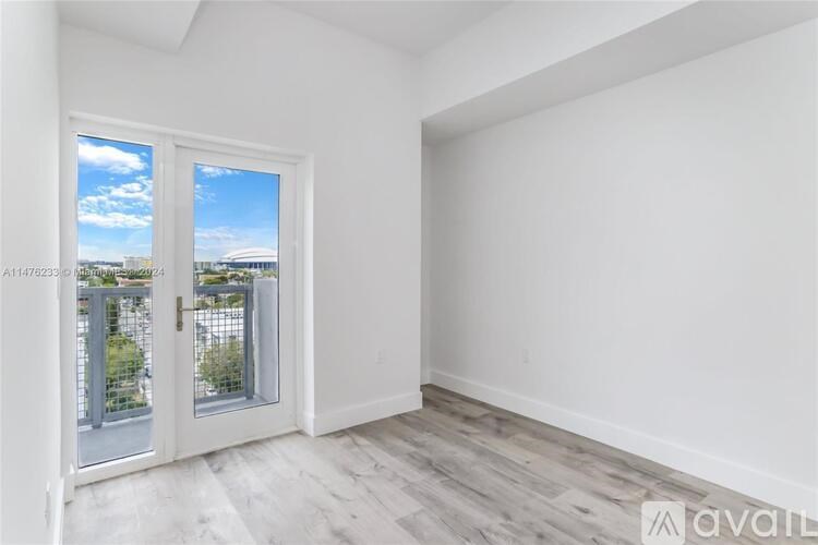 A room with a view of a balcony and the sky.