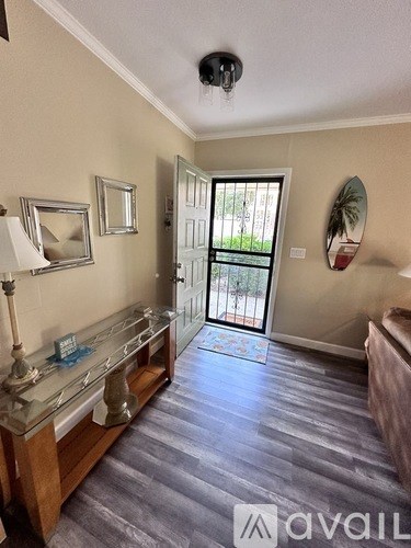 A room with a wooden floor and a glass display cabinet.