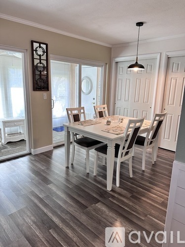A dining room with a table set for four.