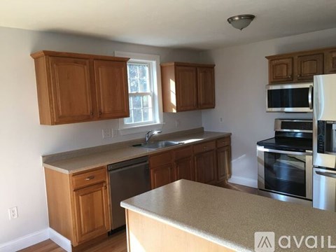 A kitchen with wooden cabinets and stainless steel appliances.