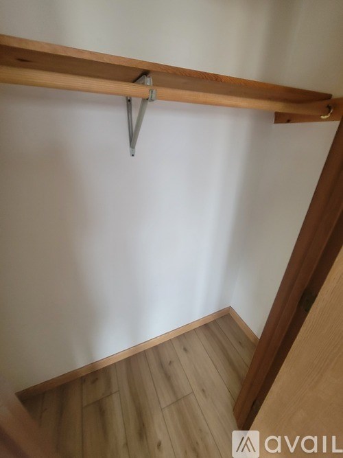 A wooden staircase with a white wall in the background.