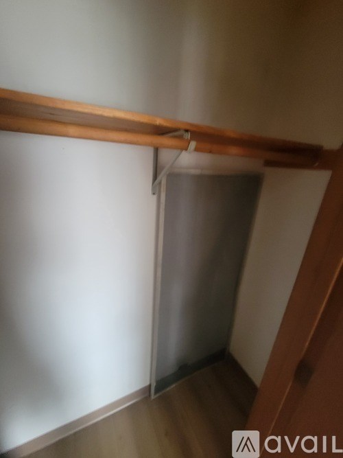 A white wall with a wooden beam and a white door.