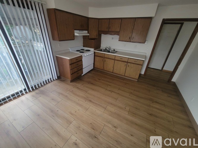 A kitchen with wooden floors and cabinets is available for rent.