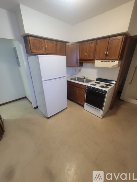 A kitchen with a white fridge and a white stove.